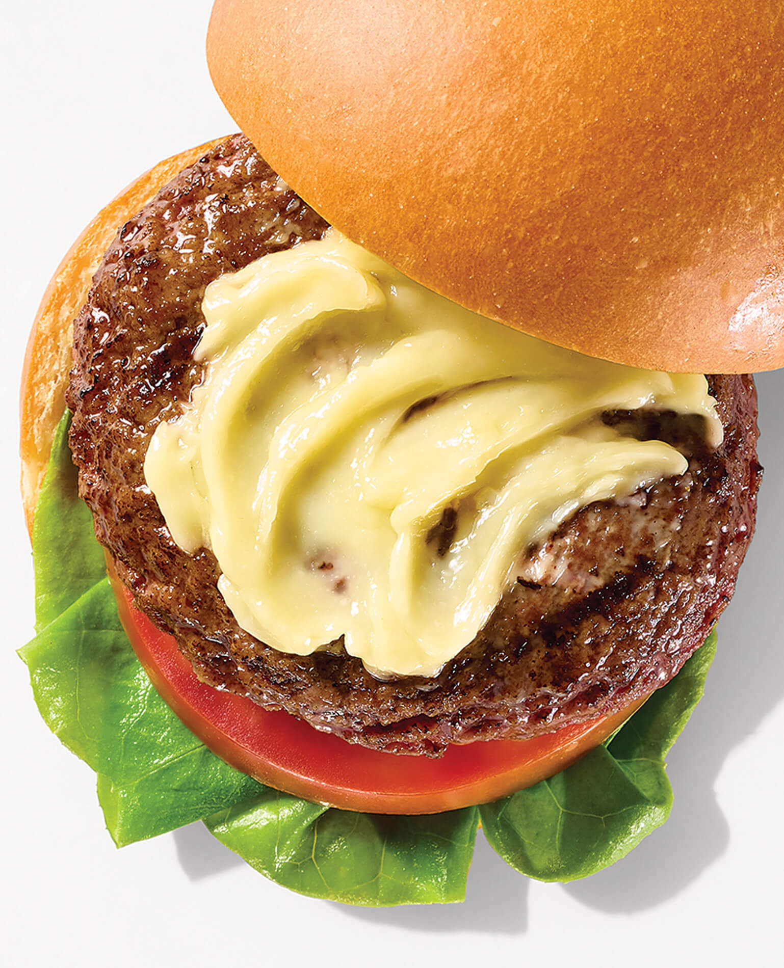 An aioli condiment spread onto a hamburger.