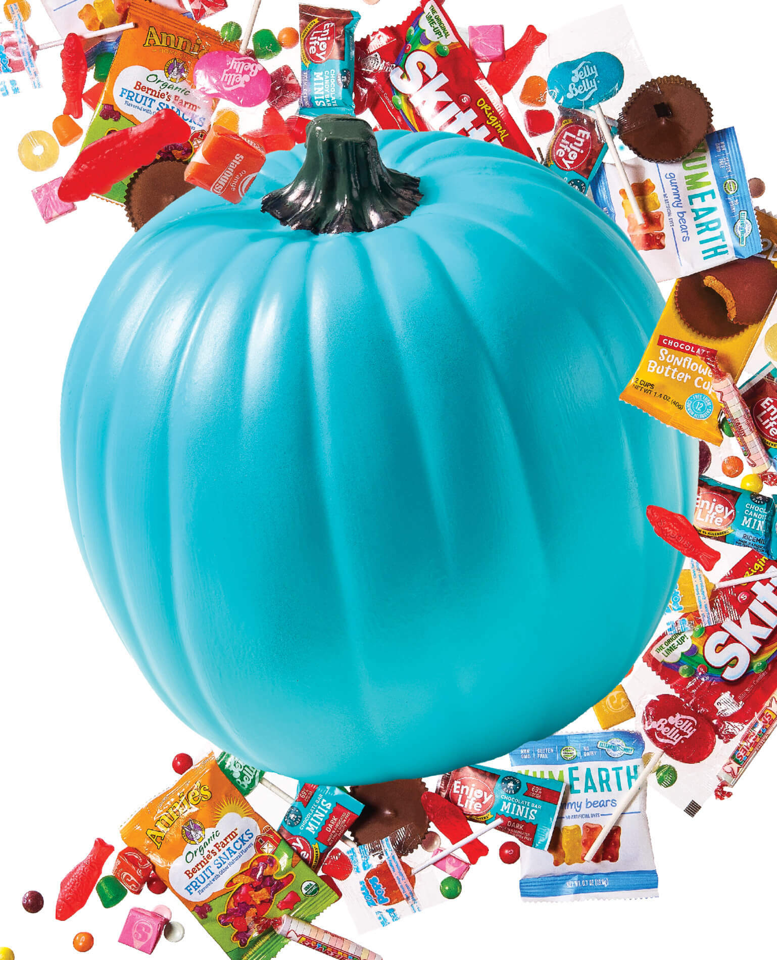 A turquoise blue pumpkin surrounded by allergen-free candy.