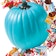A turquoise blue pumpkin surrounded by allergen-free candy.