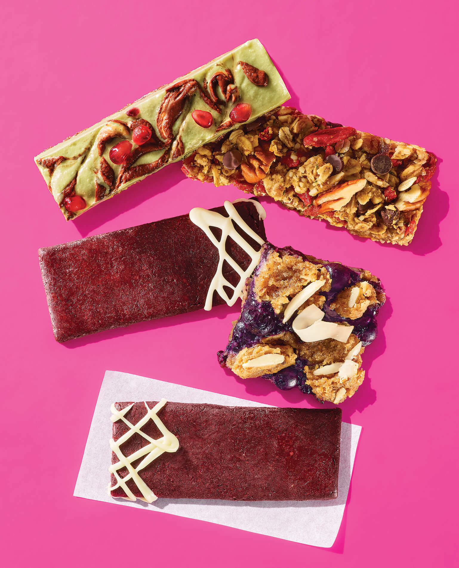 A series of breakfast and snack bars arranged on a pink background.