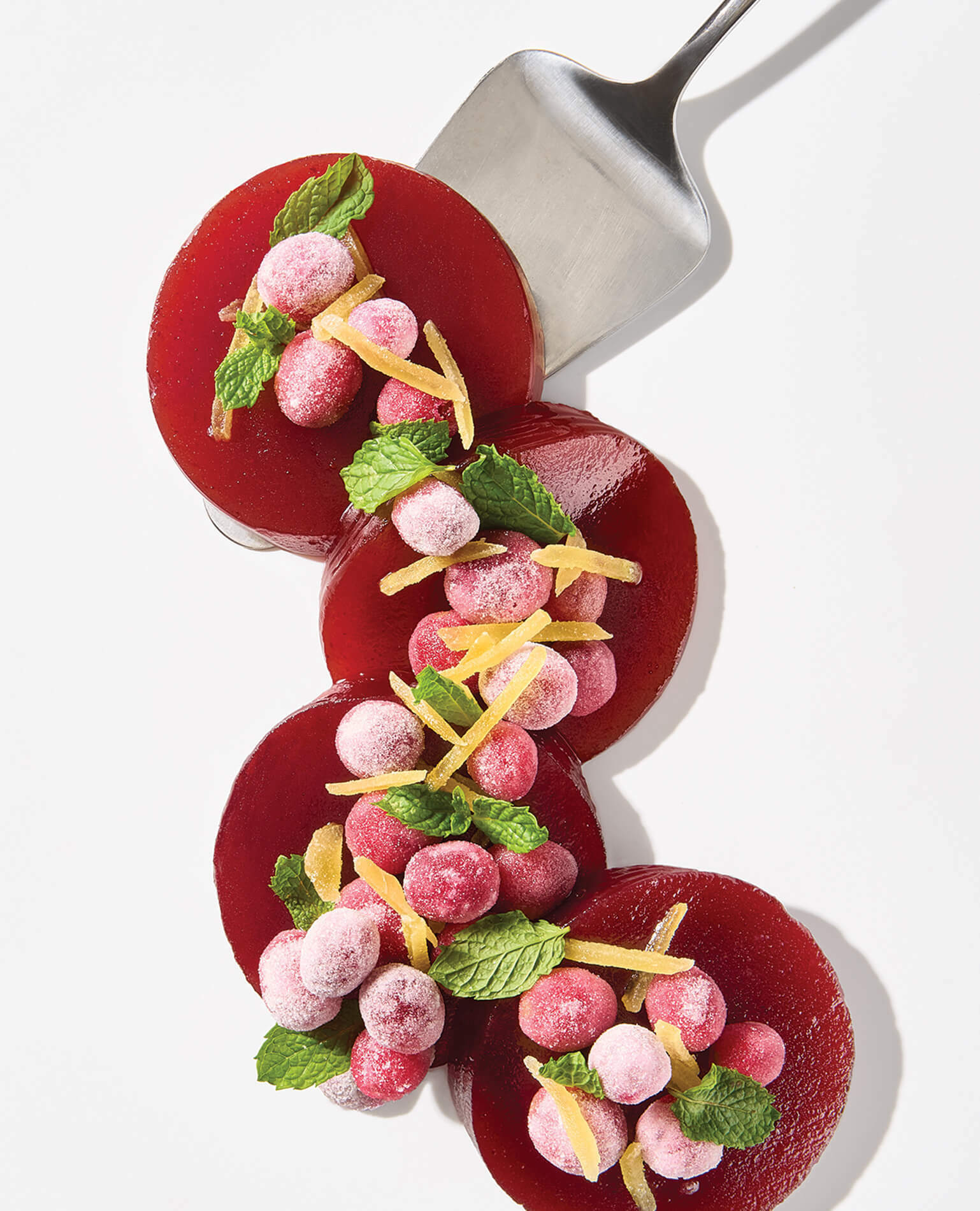 Slices of canned cranberry sauce leveled up with candied ginger.