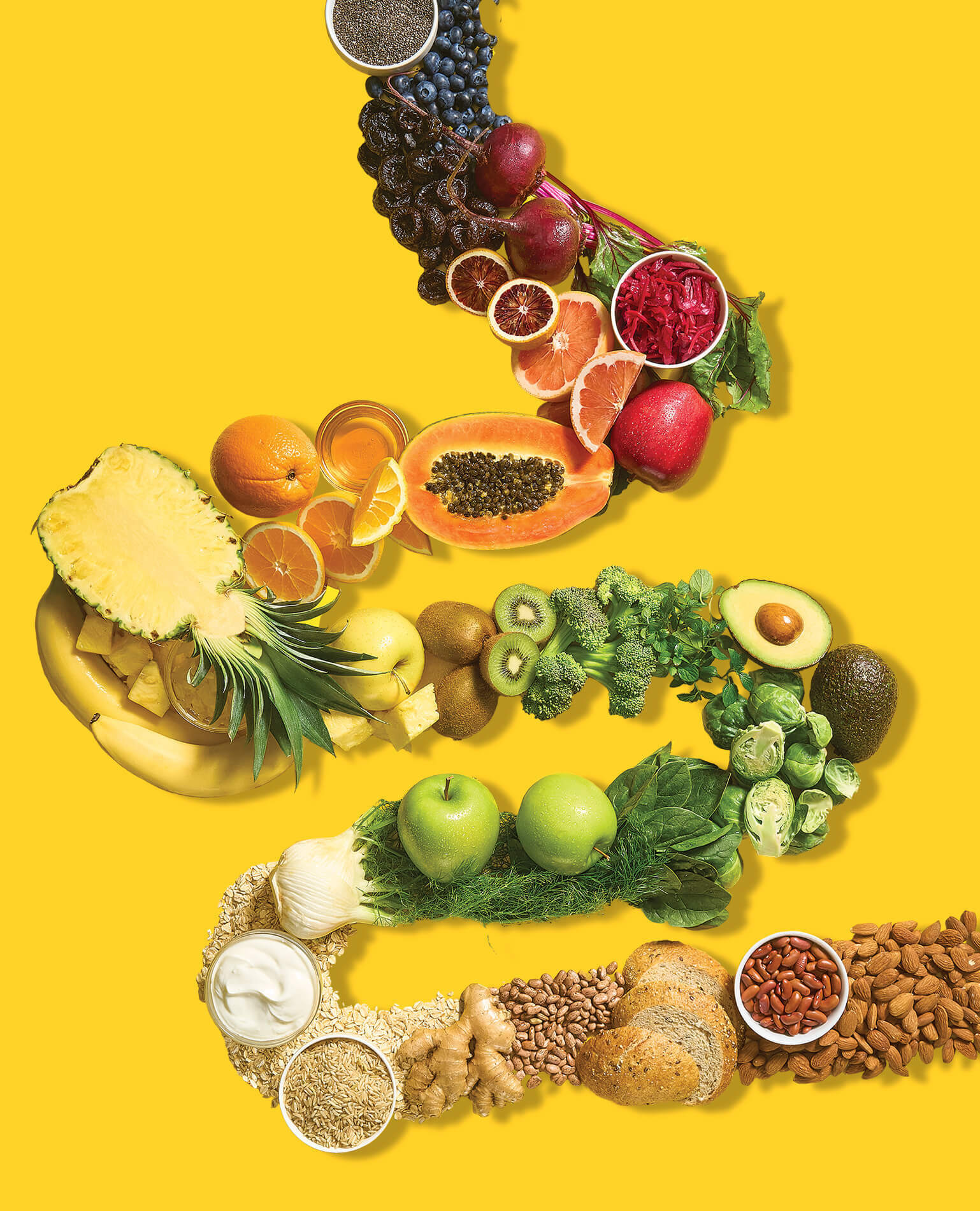 A trail of various healthy foods on a yellow background.