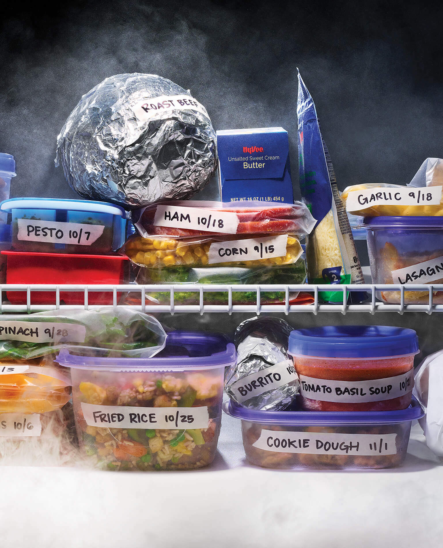 Stacks of frozen food in a freezer, all labeled.