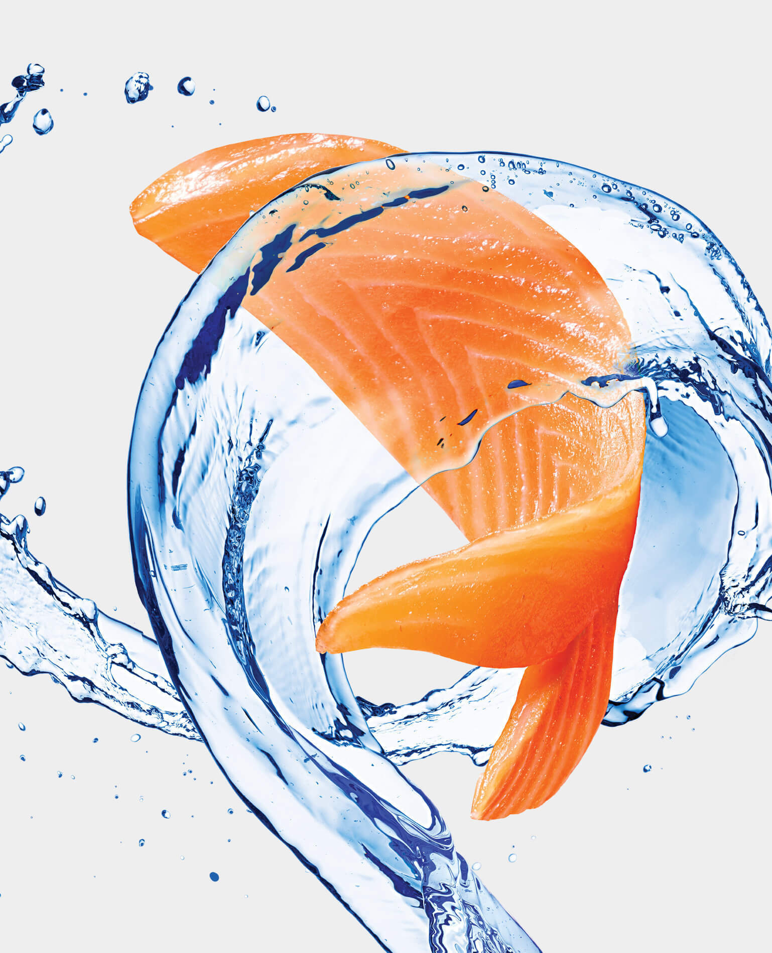 A fish filet cut into the shape of a fish jumping through a swirl of water.