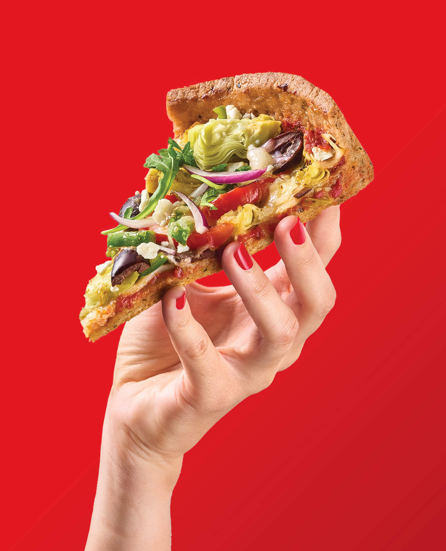 A woman's hand holding a slice of pizza on a red background.