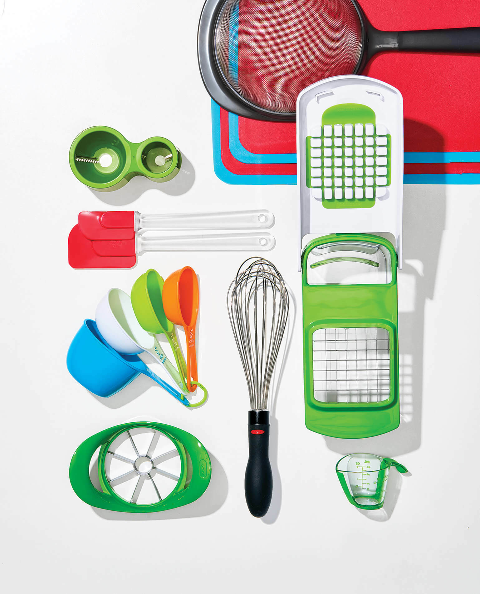 A series of kitchen gadgets spread out on a surface.