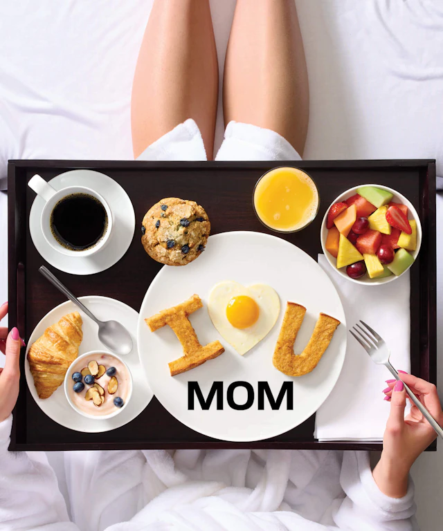 A woman enjoying breakfast in bed.