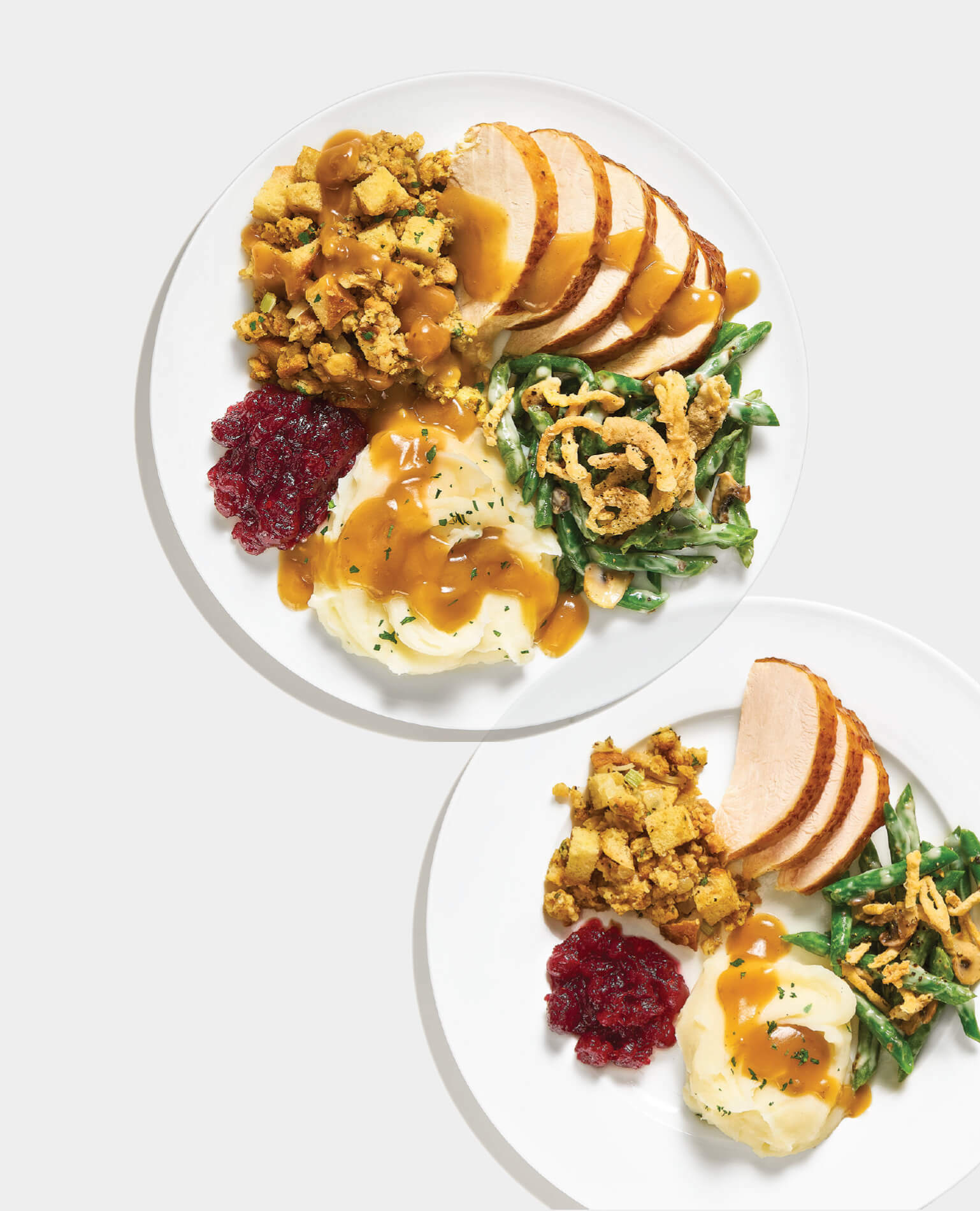 Two plates of Thanksgiving dinner, one what we take and other what we should take.