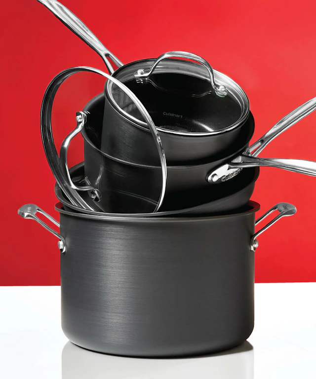 A stack of pots and pans on a red background