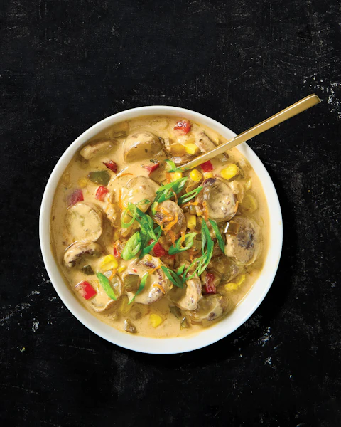 Bowl of Tortellini Alfredo with Onion Brats and Spinach