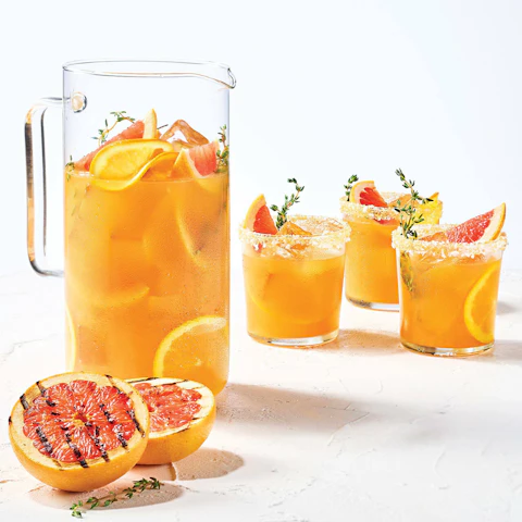 Pitcher and glasses of Grilled Citrus Salty Dog cocktail