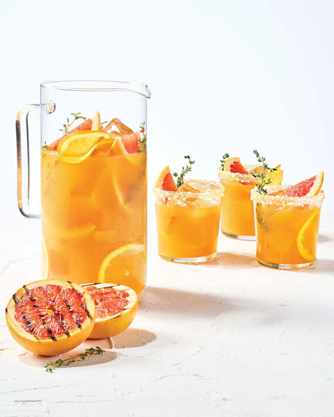Pitcher and glasses of Grilled Citrus Salty Dog cocktail