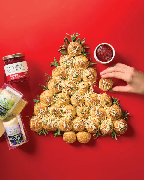 Hand taking a piece of Cheese Stuffed Pull Apart Tree