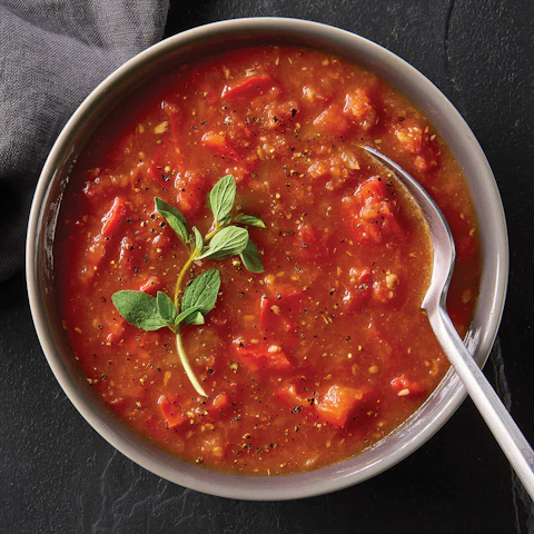 A bowl of Smoky Tomato Soup with a spoon