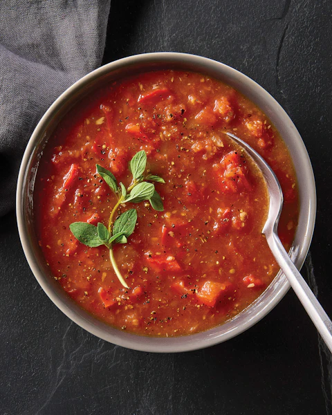 A bowl of Smoky Tomato Soup with a spoon