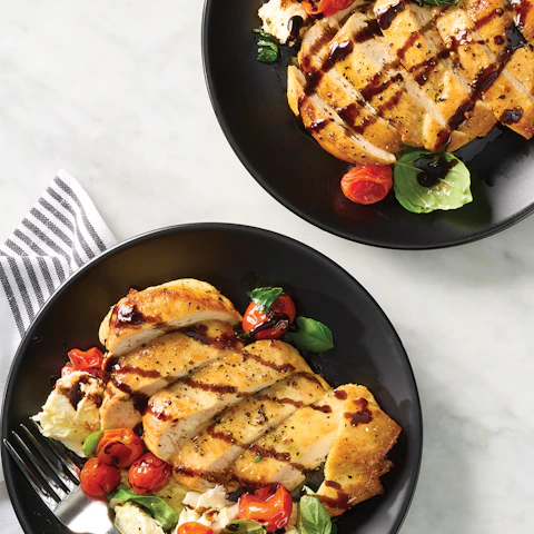 Plates of Charred Chicken Caprese