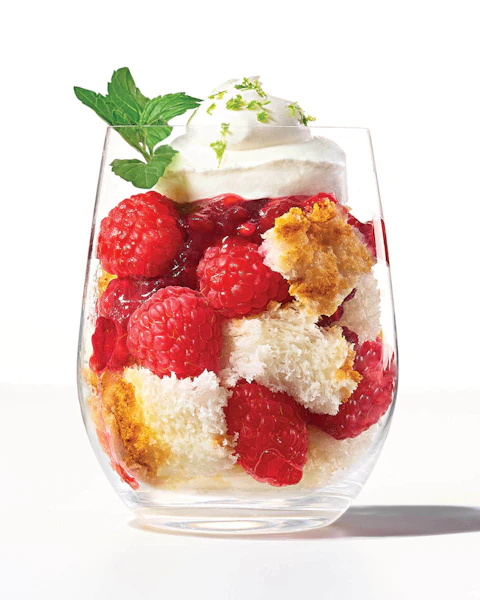 A glass of Raspberry Angel Food Cake Parfait garnished with a mint leaf