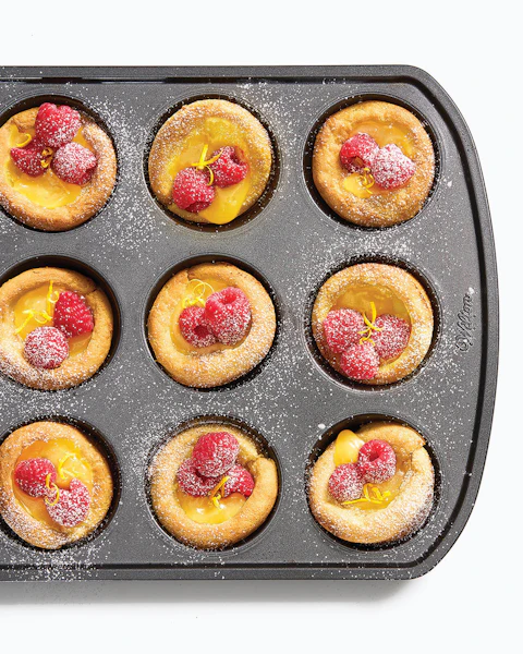 Muffin pan filled with Gluten Free Mini Dutch Babies