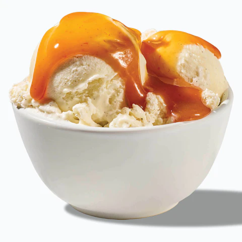 A bowl of ice cream covered in spicy Sriracha Caramel Sauce.