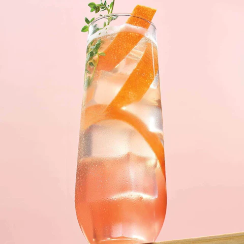 Glass of Prosecco Honey Thyme Paloma cocktail