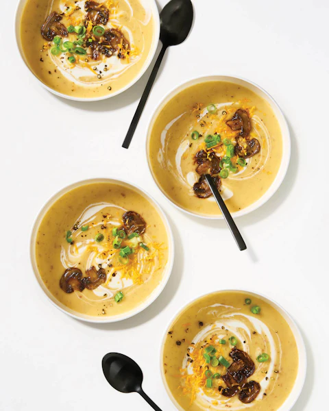 Four cups of Loaded Vegetarian Potato Soup with Mushroom Bacon with spoons
