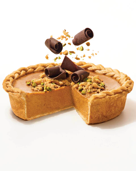A Deep Dish Bourbon Streusel Topped Apple Butter Pumpkin Pie with a slice cut out of it