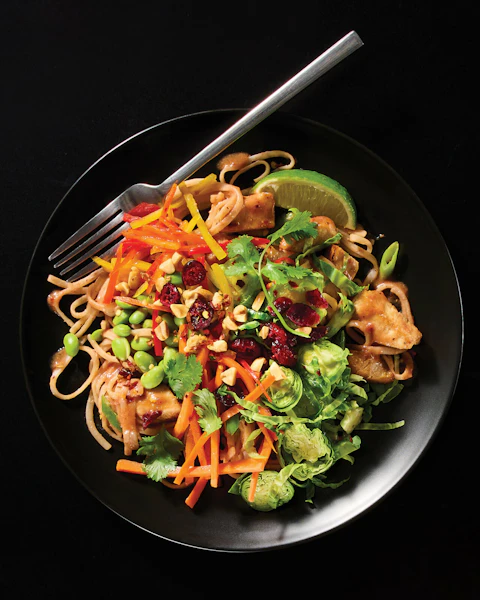 Plate of turkey cranberry pad thai salad made with Thanksgiving leftovers