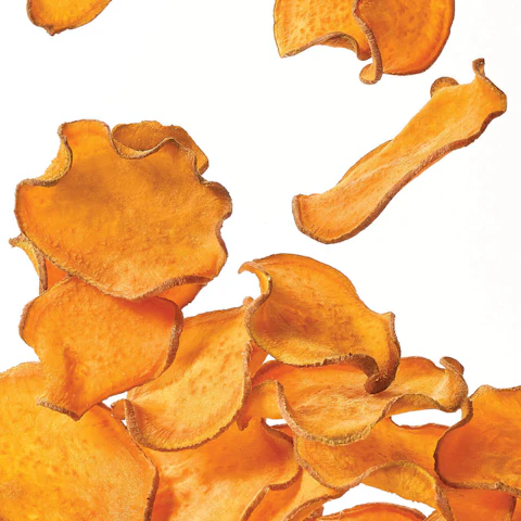 Salt and Vinegar Sweet Potato Chips being tossed in the air