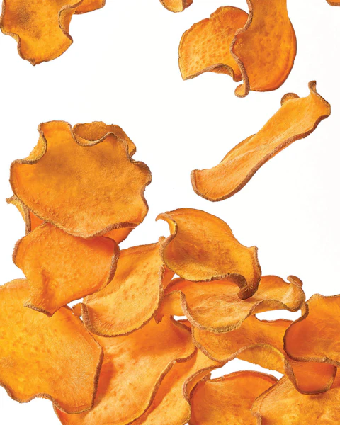 Salt and Vinegar Sweet Potato Chips being tossed in the air