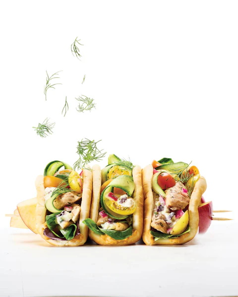 Sheet Pan Greek Chicken Gyro Wraps being sprinkled with dill