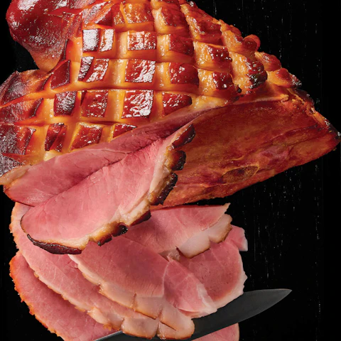 Easy Honey Glazed Ham being sliced by a knife