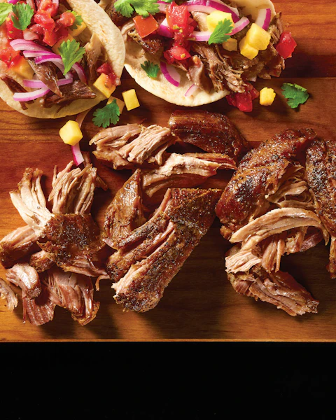 Simple Pulled Pork on a cutting board made into tacos