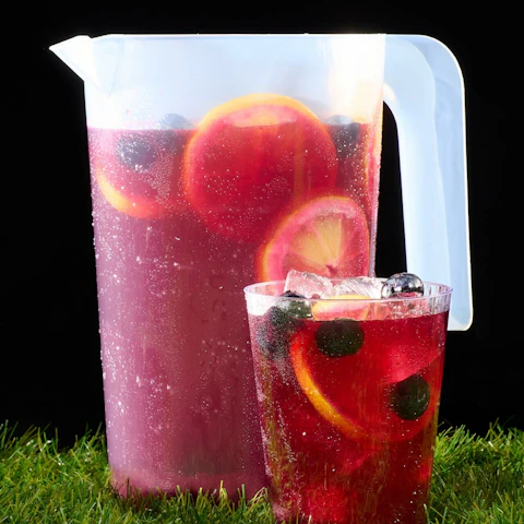 Pitcher and glass of Spiked Blueberry Lemonade