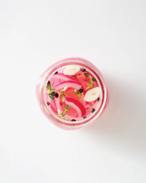 Glass jar of pickled onions.