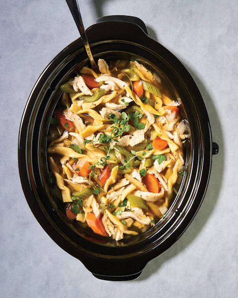 A crock pot of Slow Cooker Chicken Noodle Soup