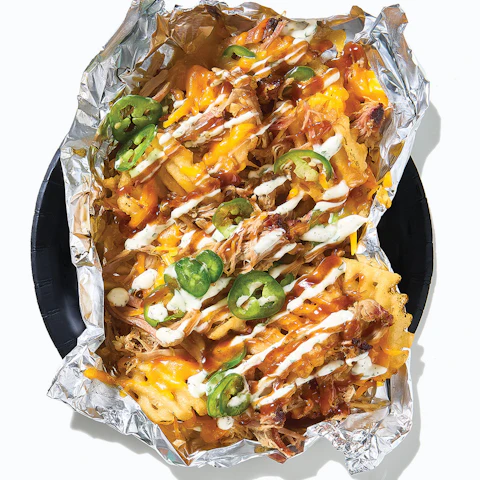 A plate of Barbecue Pork Tailgate Fries wrapped in aluminum foil