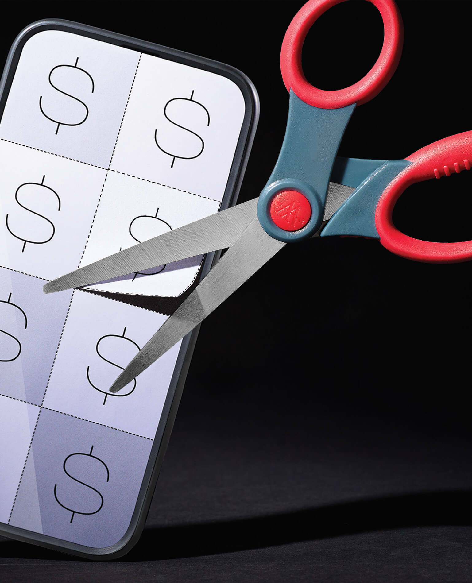 A pair of scissors cutting fake coupons out of a mobile phone.
