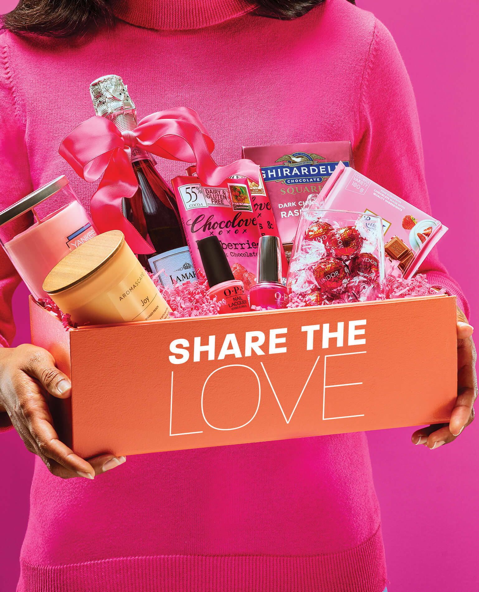 A woman holding a Valentine's Day gift basket.