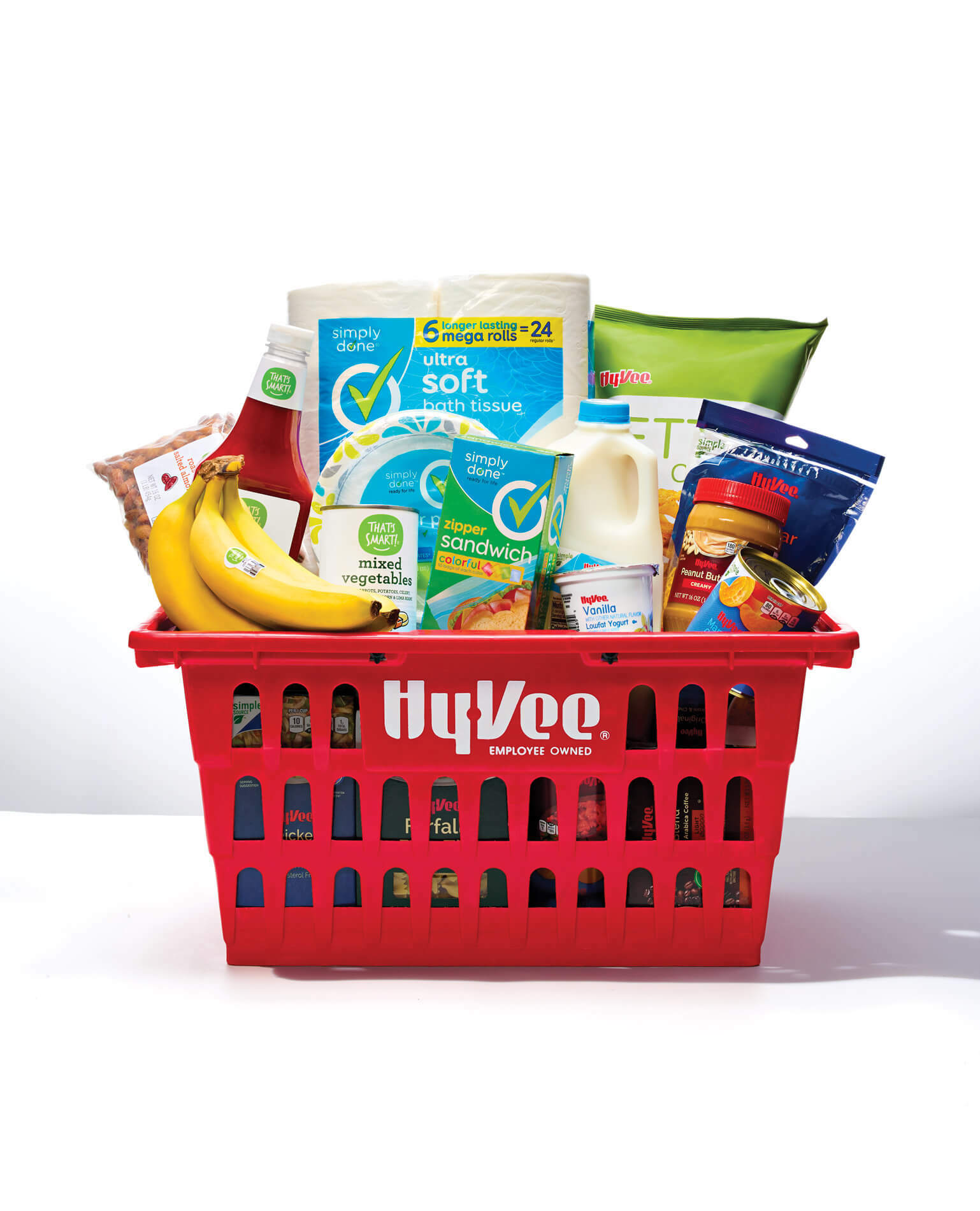 A red Hy-Vee basket filled with groceries.