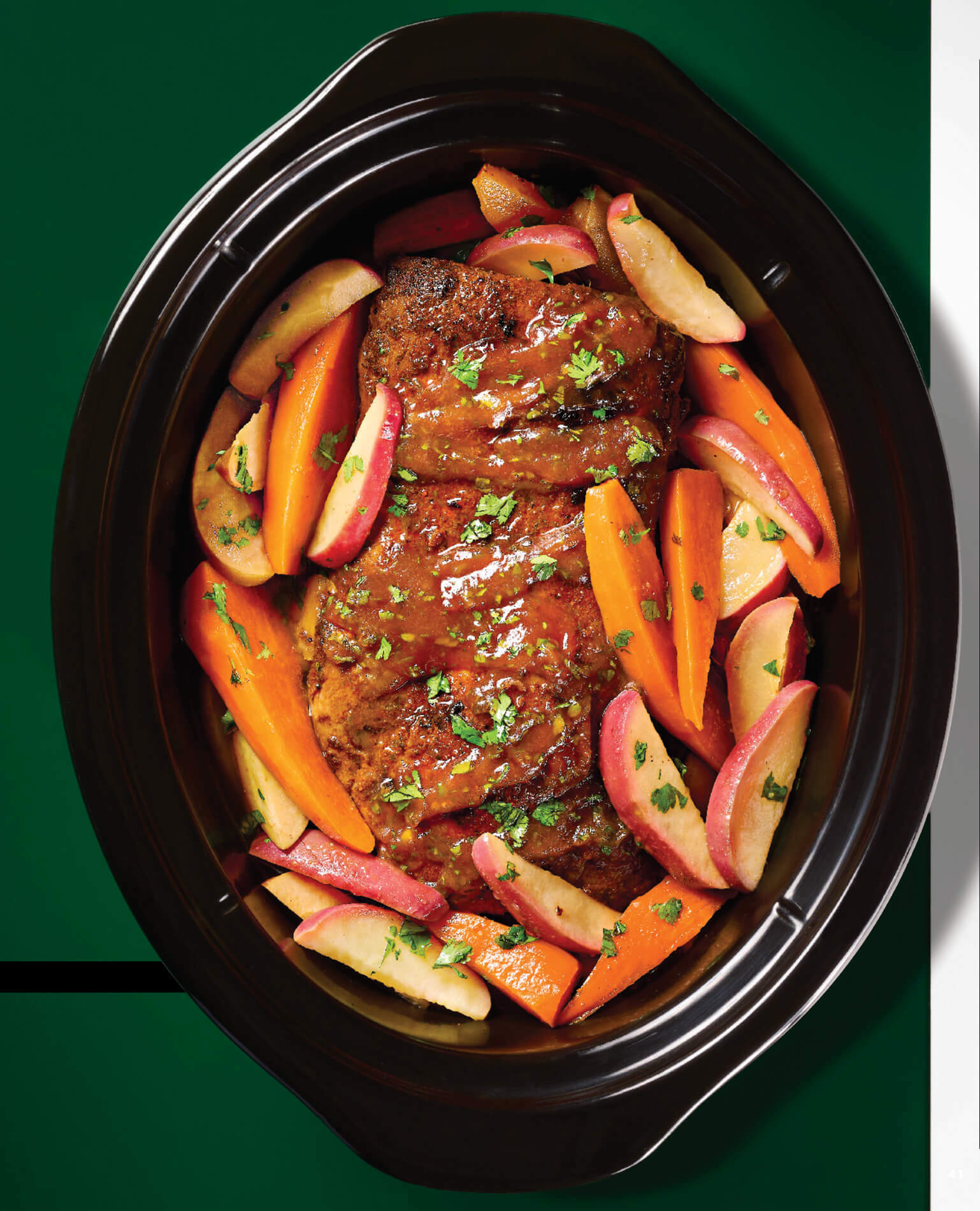 A slow cooker filled with roast and vegetables.