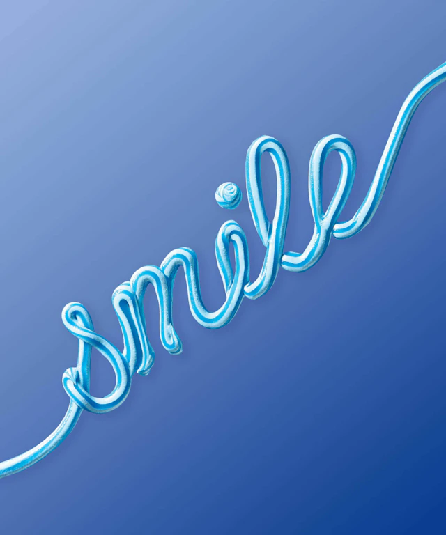 The word "smile" written in toothpaste