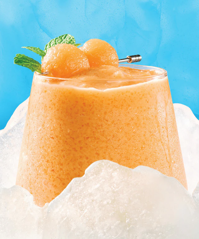 A slushie drink made from a cantaloupe cocktail.