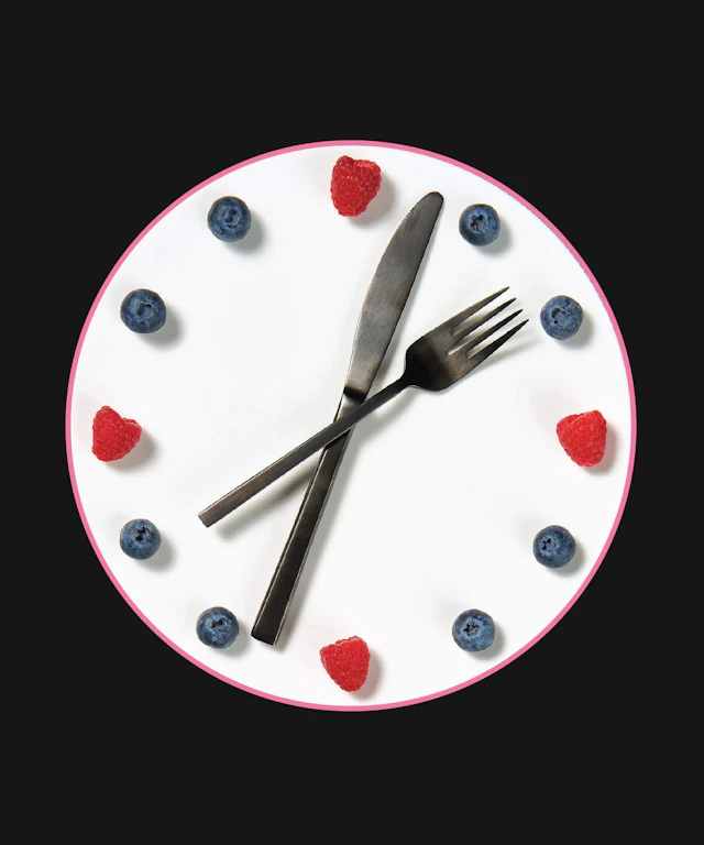 A clock with a fork and knife for hands and berries to indicate the numbers